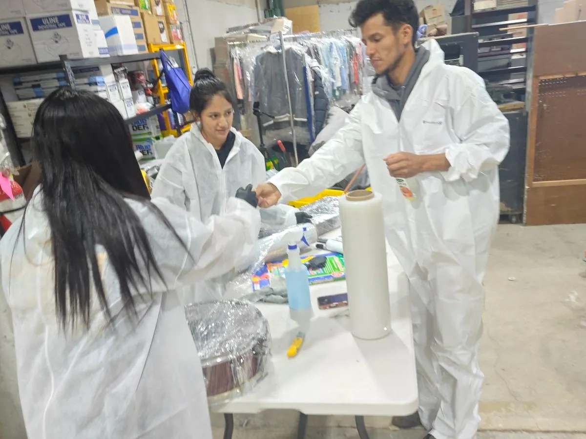 Summit contents team in protective suits cleaning and wrapping belongings